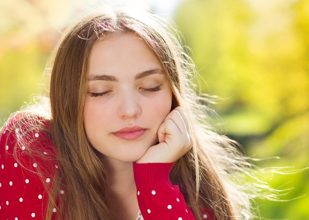 graphicstock portrait of beautiful girl in red cardigan daydreaming in green prak HA5K0Anbb 1024x729 1